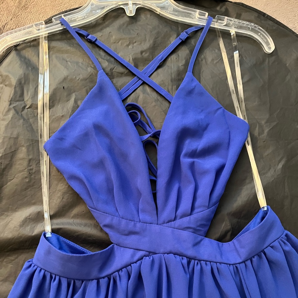 Brand new w/ tags. Long maxi royal blue dress w/ side cut outs,cross cross back